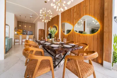 a dining room with a table and chairs and mirrors at Magic Mango Villa Huge Projector bubble bath unique design in Canggu