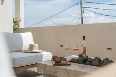 a table with two glasses of wine and a tray of food at The Revery Bali in Canggu