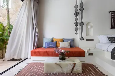 a living room with a bed and a table at The Revery Bali in Canggu
