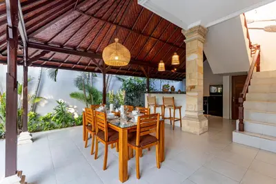 an outdoor dining room with a table and chairs at Viona 3 Villa - 3 BDR villa, walk to the beach in Seminyak