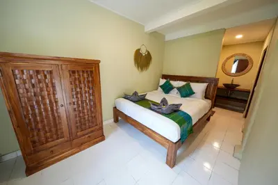 a bedroom with a bed and a wooden cabinet at Villa CHANDI 2 - Legian - Seminyak - 5 Bedroom 4 Bathroom Villa - Great Location ! in Seminyak