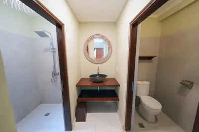 a bathroom with a sink and a toilet and a mirror at Villa CHANDI 2 - Legian - Seminyak - 5 Bedroom 4 Bathroom Villa - Great Location ! in Seminyak