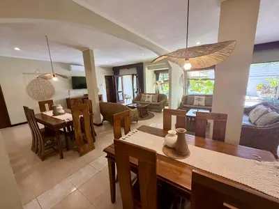 a living room with a table and a dining room at Villa CHANDI 1 - Legian-Seminyak - 8 Bedroom - 7 Bathroom Villa in Seminyak