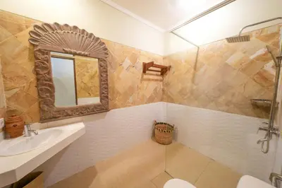 a bathroom with a sink and a toilet and a mirror at Villa CHANDI 1 - Legian-Seminyak - 8 Bedroom - 7 Bathroom Villa in Seminyak