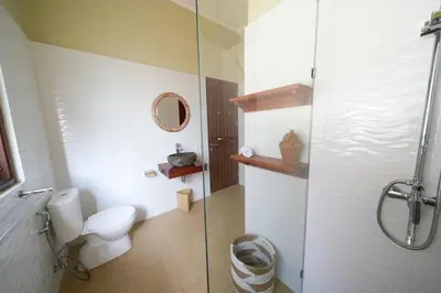 a bathroom with a toilet and a glass shower at Villa CHANDI 1 - Legian-Seminyak - 8 Bedroom - 7 Bathroom Villa in Seminyak