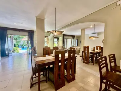 a dining room and living room with a table and chairs at Villa CHANDI 1 - Legian-Seminyak - 8 Bedroom - 7 Bathroom Villa in Seminyak