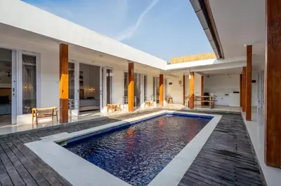 an indoor swimming pool in a villa at Lumturi House - Centrally Located in Seminyak