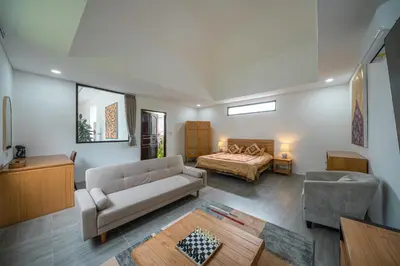 a living room with a couch and a bed at Villa Cempaka Ungu - Tranquil & Chic Pool 4-Bedroom Villa In The Heart Of Seminyak in Seminyak