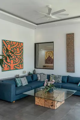 a living room with blue couches and a coffee table at Villa Cempaka Ungu - Tranquil & Chic Pool 4-Bedroom Villa In The Heart Of Seminyak in Seminyak
