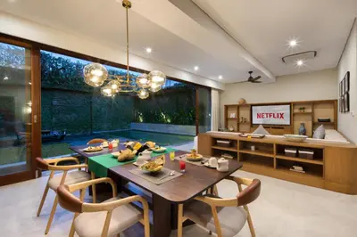 a dining room with a table and chairs at Kolila Villa Seminyak by Ini Vie Hospitality in Seminyak