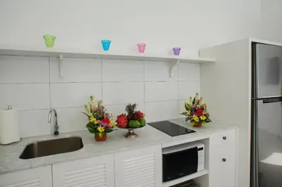 a kitchen with flowers and vases on a counter at Villa Ley Hidden Gem Villa 1 Bedroom Private Pool Seminyak in Seminyak