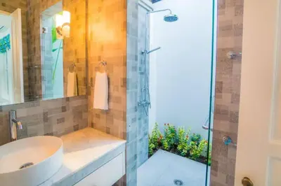 a bathroom with a sink and a glass shower at Villa Ley Hidden Gem Villa 1 Bedroom Private Pool Seminyak in Seminyak