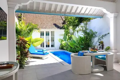 a patio with a pool and a table and chairs at Villa Ley Hidden Gem Villa 1 Bedroom Private Pool Seminyak in Seminyak