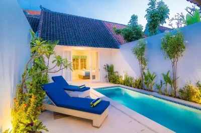 a villa with a swimming pool and a house at Villa Ley Hidden Gem Villa 1 Bedroom Private Pool Seminyak in Seminyak