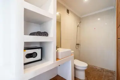 a bathroom with a toilet and a sink at Lumturi House - Centrally Located in Seminyak