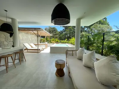 a living room with a couch and a table at Villa Anwa Cove - Gorgeous 6-BR & 2-Pool Villa in Bali in Umalas