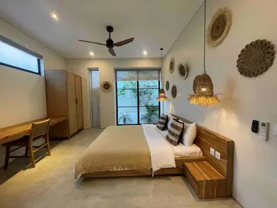 a bedroom with a bed and a ceiling fan at Villa Anwa Cove - Gorgeous 6-BR & 2-Pool Villa in Bali in Umalas