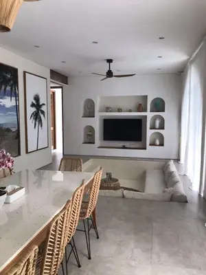 a living room with a television and a table and chairs at Villa Anwa Cove - Gorgeous 6-BR & 2-Pool Villa in Bali in Umalas