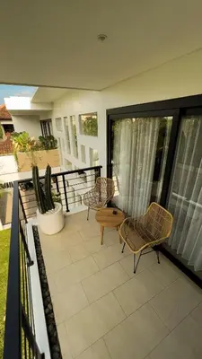 a patio with chairs and a table on a balcony at Admire Villa - a luxury private villa with Pool in Legian