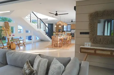 a living room with a couch and a dining room at Admire Villa - a luxury private villa with Pool in Legian