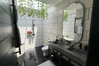 a bathroom with a sink and a toilet and a mirror at Admire Villa - a luxury private villa with Pool in Legian