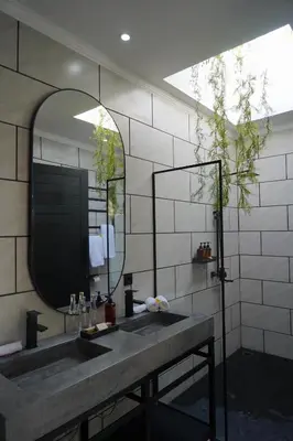 a bathroom with a sink and a mirror at Admire Villa - a luxury private villa with Pool in Legian