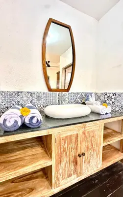 a bathroom with a sink and a mirror at Casa Sessy Legian in Seminyak