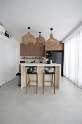 a kitchen with a island with chairs and lights at Casa Z - Seminyak 3BR Villa with Private Pool in Seminyak
