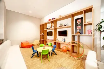 a living room with a table and chairs at Euphoria Hotel in Legian