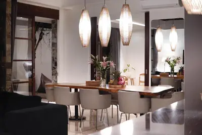 a dining room with a table and chairs at Villa Duadewi 4BR in the Heart of Seminyak by Santi Management in Seminyak