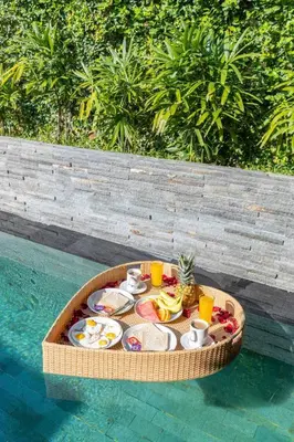 a tray of food on a table in the water at Luxurious Double King Villa w/Pool & WiFi+ Carpark in Seminyak
