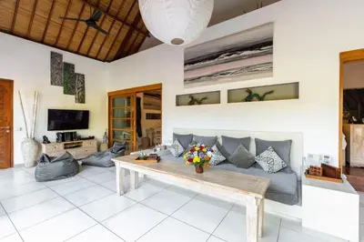 a living room with a couch and a table at Luxurious Double King Villa w/Pool & WiFi+ Carpark in Seminyak