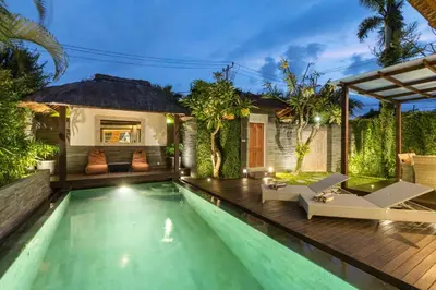 a swimming pool with a villa in the background at Luxurious Double King Villa w/Pool & WiFi+ Carpark in Seminyak