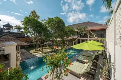 an overhead view of a swimming pool with a green umbrella at Balinese Luxury Amisha Villa: 4BR in Seminyak in Seminyak