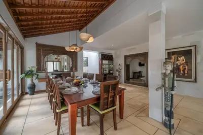 a dining room with a wooden table and chairs at Balinese Luxury Amisha Villa: 4BR in Seminyak in Seminyak