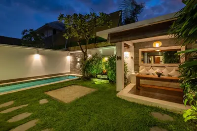 a garden with a bench and a swimming pool at 2 Br Villa in Seminyak with private Pool and Parking in Seminyak