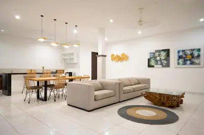 a living room with a couch and a table at Nossa Casa Villa in Seminyak