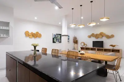 a kitchen and dining room with a table and chairs at Nossa Casa Villa in Seminyak