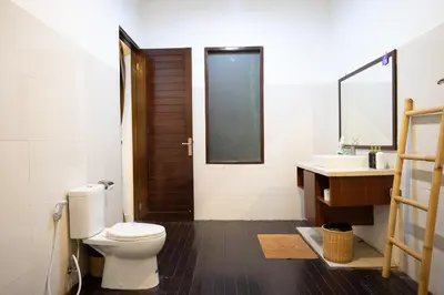 a bathroom with a toilet and a sink at Nossa Casa Villa in Seminyak