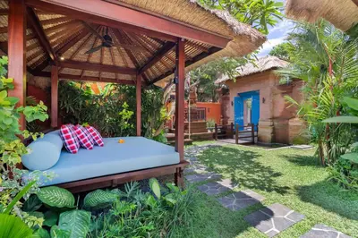 a bed in a gazebo in a garden at Villa Mahkota Seminyak in Seminyak