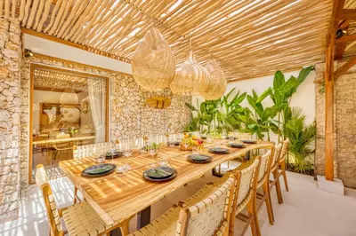 a dining room with a long wooden table and chairs at Villa Miami - New Luxury 7BDR Prime Location in Seminyak