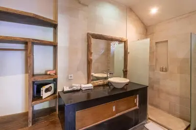 a bathroom with a sink and a mirror at Enclose living 5Br Villa Center of Seminyak Near Beach in Seminyak