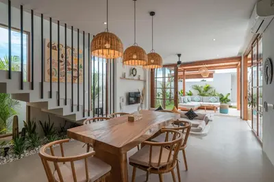 a dining room with a wooden table and chairs at Villa LouLou Bali - Brand New Tropical 3BR Villa Next to Canggu in Canggu