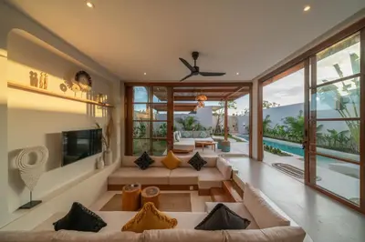an open living room with a couch and a fireplace at Villa LouLou Bali - Brand New Tropical 3BR Villa Next to Canggu in Canggu