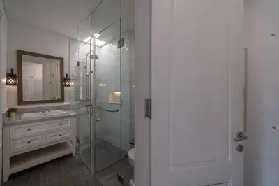 a bathroom with a glass shower and a sink at Blanc Mediterranean: 3BR in Central Canggu in Canggu