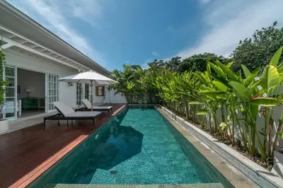 a swimming pool in the backyard of a villa at Blanc Mediterranean: 3BR in Central Canggu in Canggu
