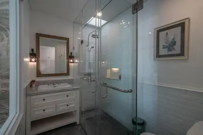 a bathroom with a glass shower and a sink at Blanc Mediterranean: 3BR in Central Canggu in Canggu