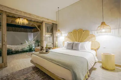 a bedroom with a large bed in a room at Villa Aarka - Chic Balinese Bohemian Retreat in Seminyak in Seminyak