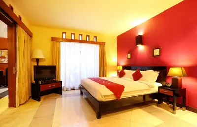 a bedroom with a large bed and a television at The Bali Bliss Villa in Seminyak
