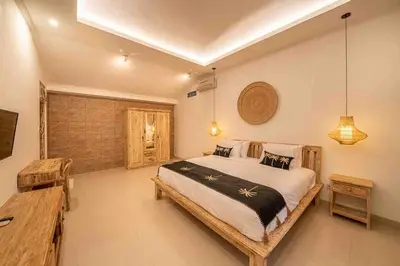 a bedroom with a large bed in a room at Villa James Seminyak in Seminyak